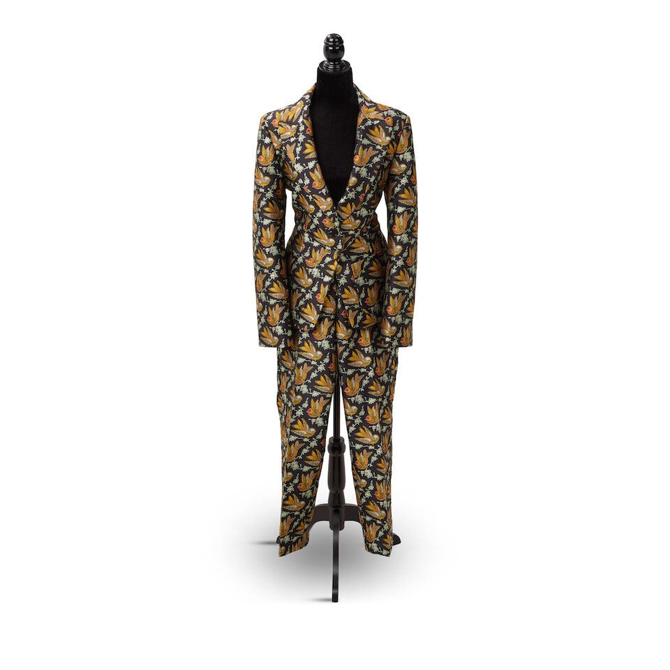TWO DESIGNER PANT SUITS WORN TO LET THE CANARY SING EVENTS 2023-2024: TWO DESIGNER PANT SUITS WORN TO LET THE CANARY SING EVENTS 2023-2024 Comprising an Etro brocade bird patterned pant suit, 46, and a 2023 Versace neon yellow pant suit, 40 and 44. (4) Footnotes: Let