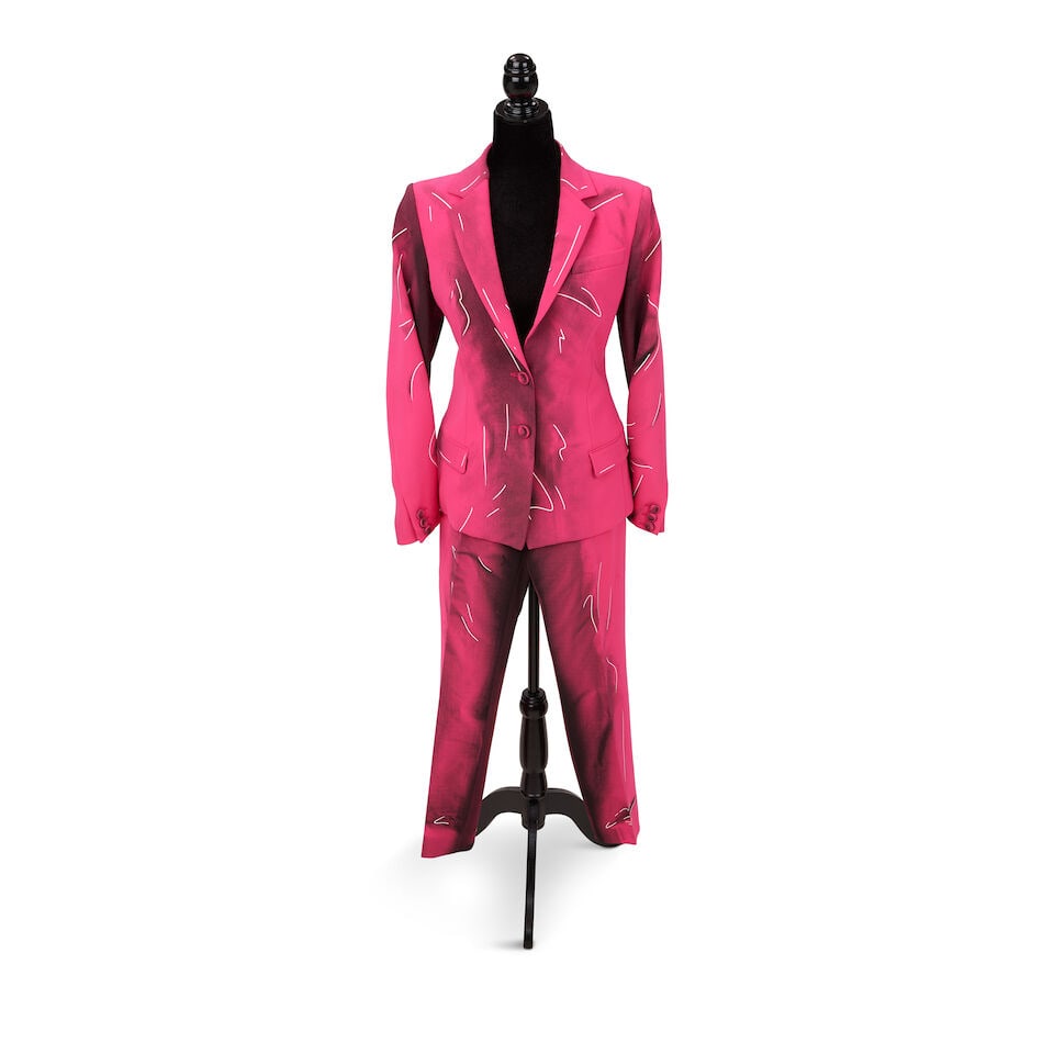 A MOSCHINO COUTURE! PINK PANT SUIT Jeremy Scott, Fall 2016: A MOSCHINO COUTURE! PINK PANT SUIT Jeremy Scott, Fall 2016 Comprising a blazer and trouser, both 10, together with a Moschino black belted fitted dress, 8. (3) Footnotes: The pink suit worn in a