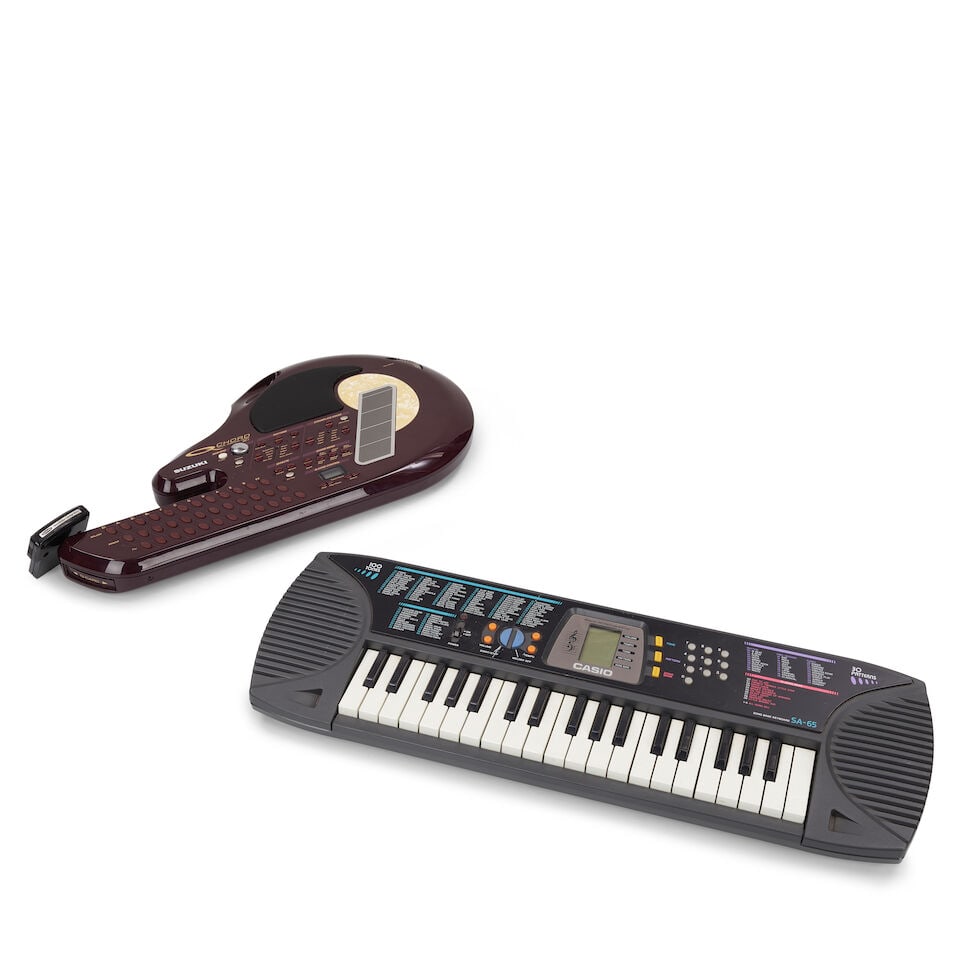 A SUZUKI Q CHORD DIGITAL SONGCARD GUITAR AND A TOUR-USED CASIO SA-65 SONG BANK KEYBOARD 1990s/ea...: A SUZUKI Q CHORD DIGITAL SONGCARD GUITAR AND A TOUR-USED CASIO SA-65 SONG BANK KEYBOARD 1990s/early 2000s The songcard guitar model QC-1, serial U00122786, the Casio a 37-mini-key electronic