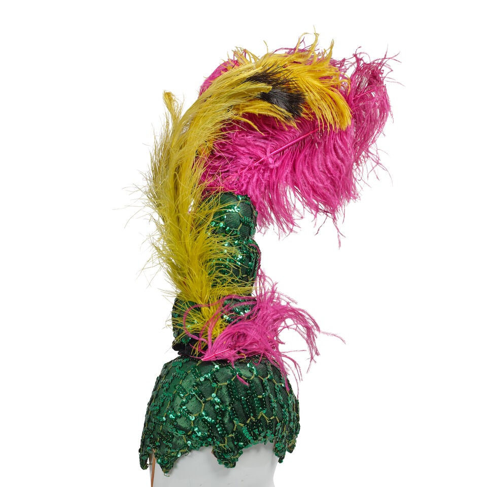 THREE SEQUINED AND FEATHERED SHOWGIRL HEADDRESSES, MASKS, AND FANS: THREE SEQUINED AND FEATHERED SHOWGIRL HEADDRESSES, MASKS, AND FANS Comprising a green sequined hat with multicolor feathers, a turquoise sequined headdress with feathers, and a red sequined headdress