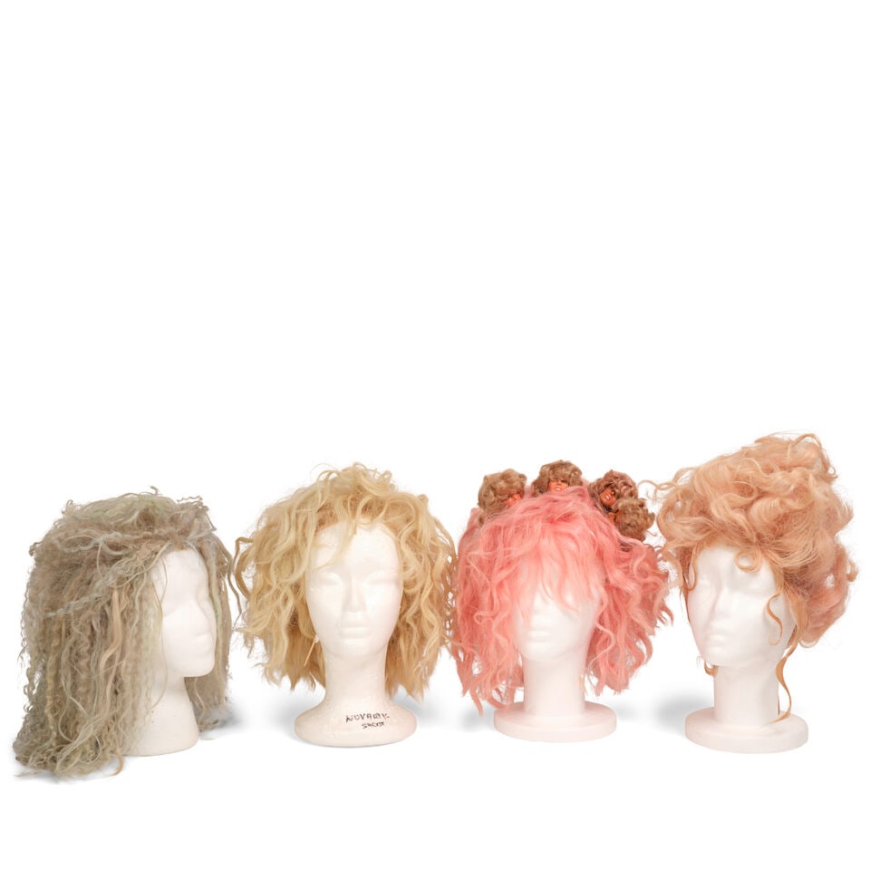 TEN PROMOTIONAL PHOTOSHOOT AND EVENT WORN WIGS 2013-2025: TEN PROMOTIONAL PHOTOSHOOT AND EVENT WORN WIGS 2013-2025 Comprising two curly blonde wigs, two curly pink wigs, one with four small doll heads, a curly aquamarine wig, a blonde shag wig, a long pink