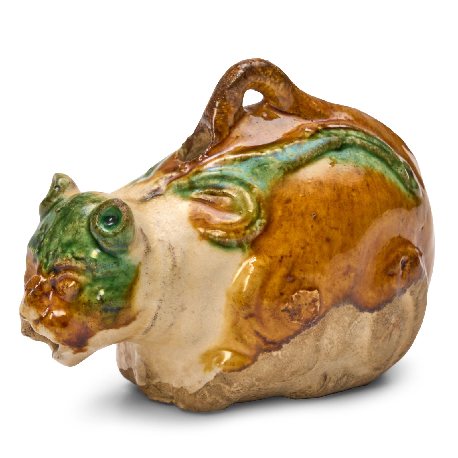 A Sancai-Glazed Ceramic Cat-Form Water Dropper China, Liao Dynasty: A Sancai-Glazed Ceramic Cat-Form Water Dropper China, Liao Dynasty Molded in the form of a crouched cat with an open mouth in crouched position, with molded details of a collar and attached ribbons, w