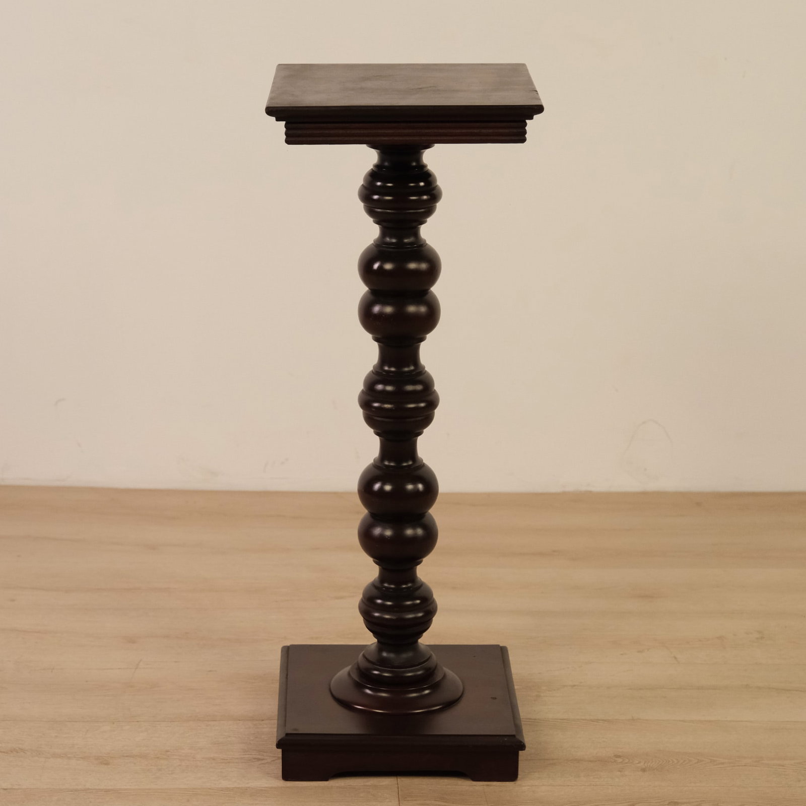 Wooden Pedestal or Plant Stand, c. Mid 20th Century: Wooden pedestal/plant stand featuring a bold, sculptural design. A square top sits atop a dramatic bobbin-turned column of stacked spherical elements, rising from a stepped square base, giving the