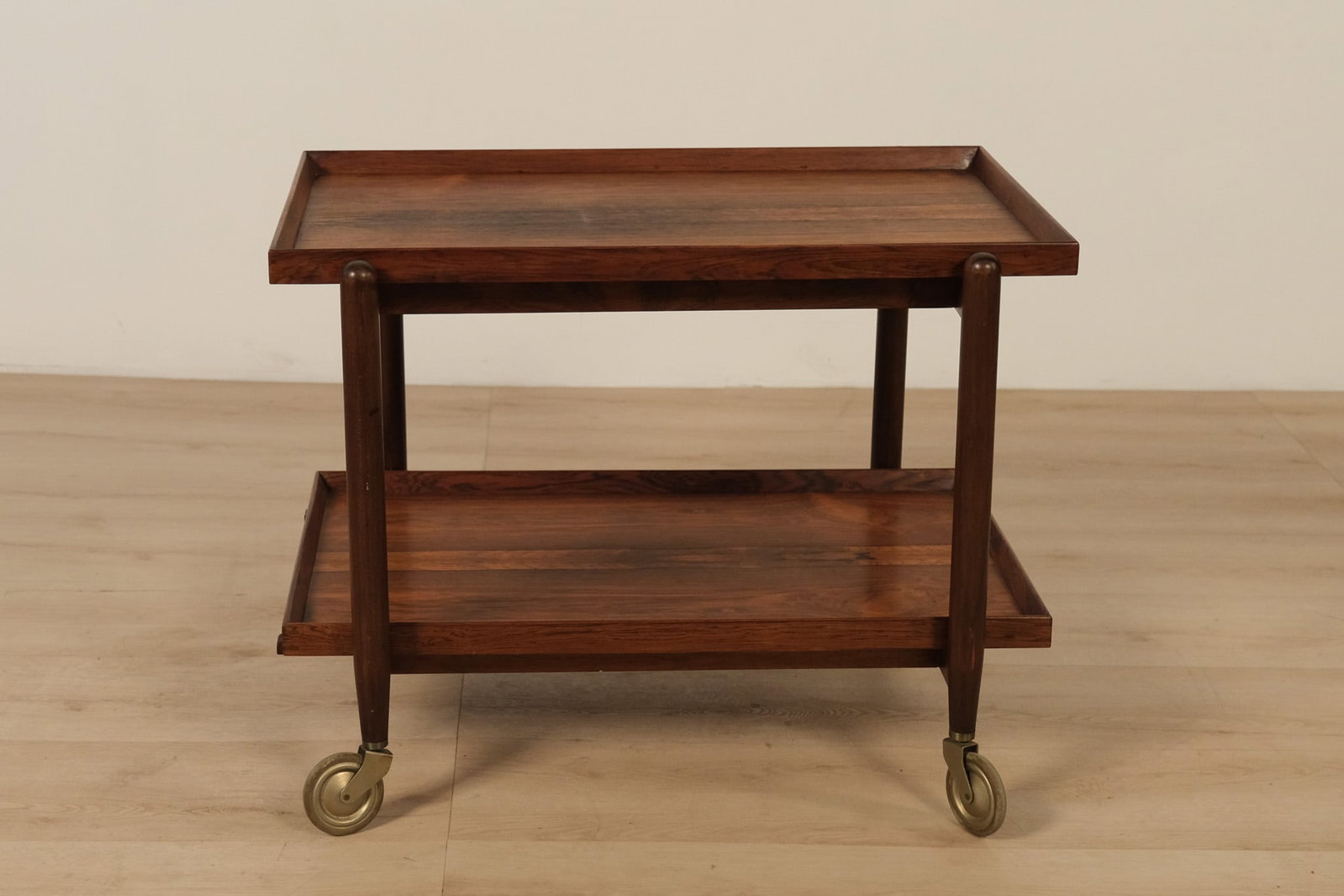Mid-century-modern Bar Cart by Poul Hundevad: Mid-century-modern Danish rosewood serving cart designed by Poul Hundevad, featuring a pull_out top and removable lower tray, stamped ?Made in Denmark? on the underside. Beautifully crafted in rich