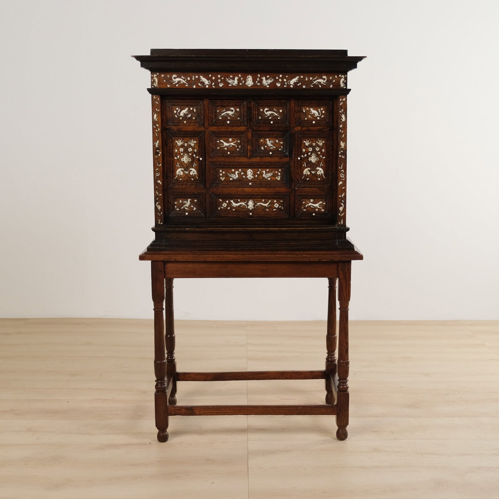 Italian Inlaid Walnut Cabinet on Stand, c. 1850: Italian walnut inlaid cabinet on stand, c. 1850. The front is fitted with a symmetrical arrangement of deeply molded panel doors & drawers, each richly decorated in contrasting light inlay. The