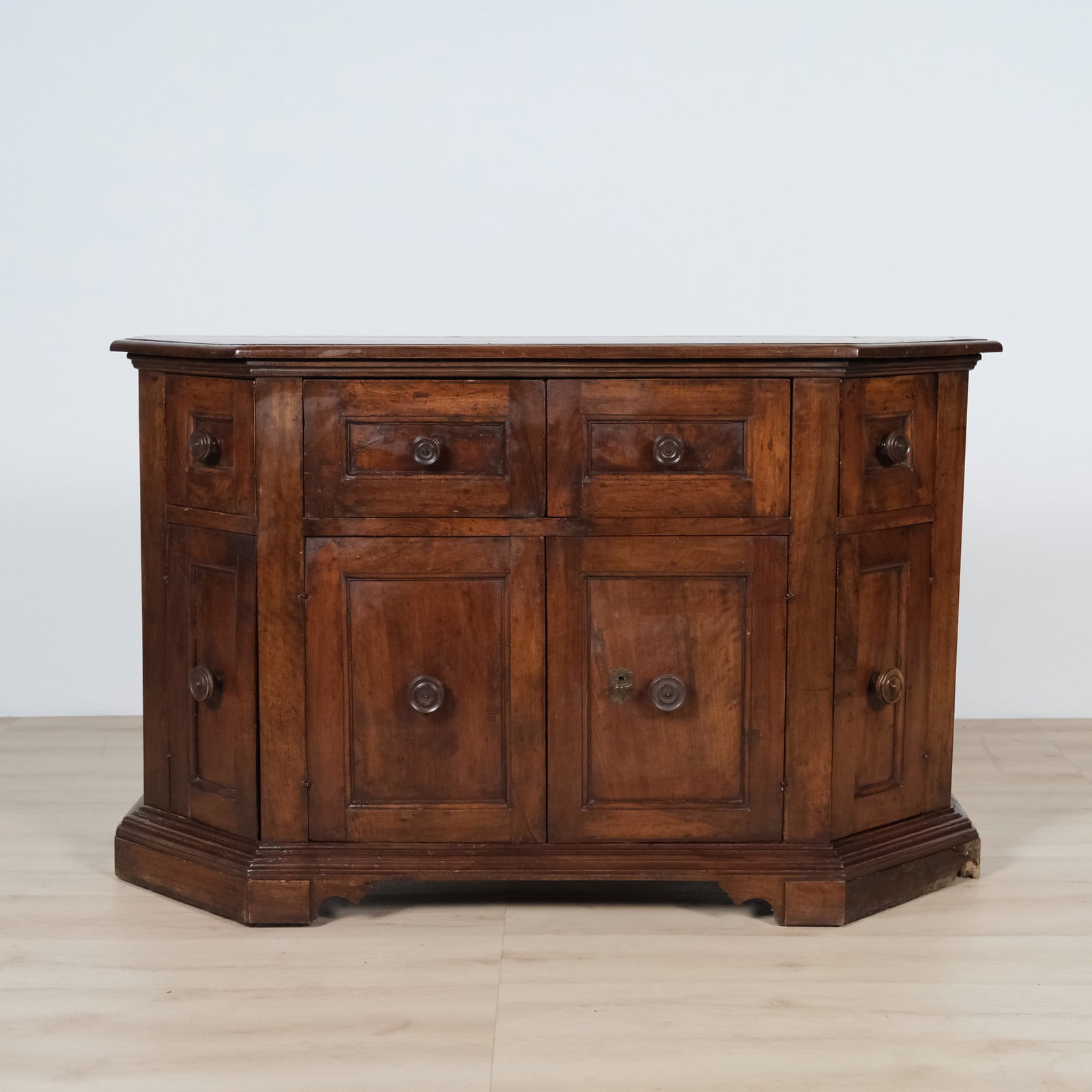 English Oak Corner Cabinet, c. 19th century: TEST Wooden pedestal/plant stand featuring a bold, sculptural design. A square top sits atop a dramatic bobbin-turned column of stacked spherical elements, rising from a stepped square base, giving
