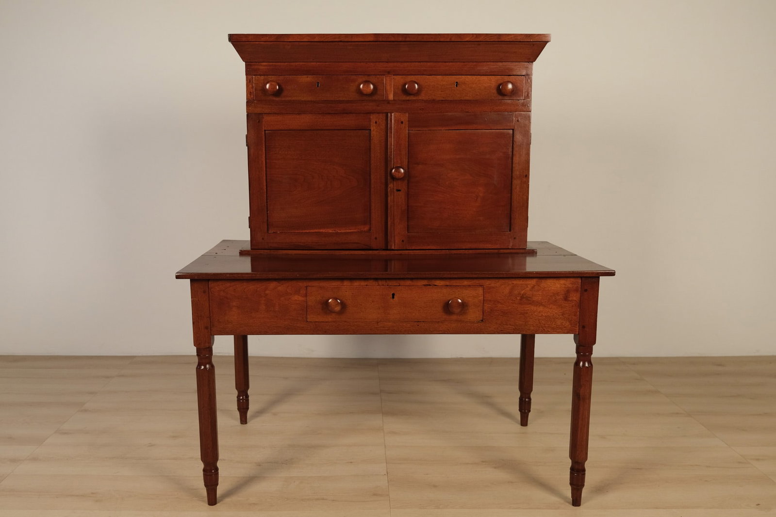 Walnut Commandant's Desk: One piece walnut hand planed wooden desk, with an integrated upper cabinet. Potentially crafted by Andrew Varner or Milton H. Key of Rockbridge Co., Virginia, for the Virginia Military Institute. It