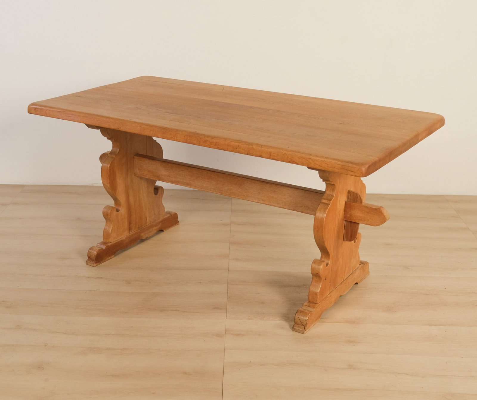 Henning Kjaernulf Danish Oak Dining Table, c. 1970: A sculptural Danish oak dining table attributed to Henning Kjaernulf. The table pairs a clean rectangular solid top with substantial trestle supports, shaped with the designer's characteristic