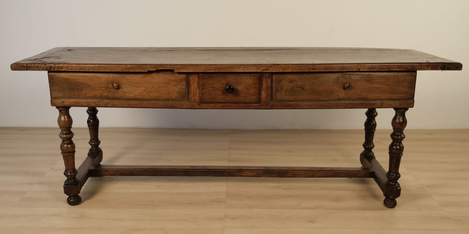 Continential Oak Table, c. 1850: A substantial antique oak table with handsome late 17th- to early 18th-century Continental character. The rectangular plank top is framed with a simple molded edge and rests over a three-drawer