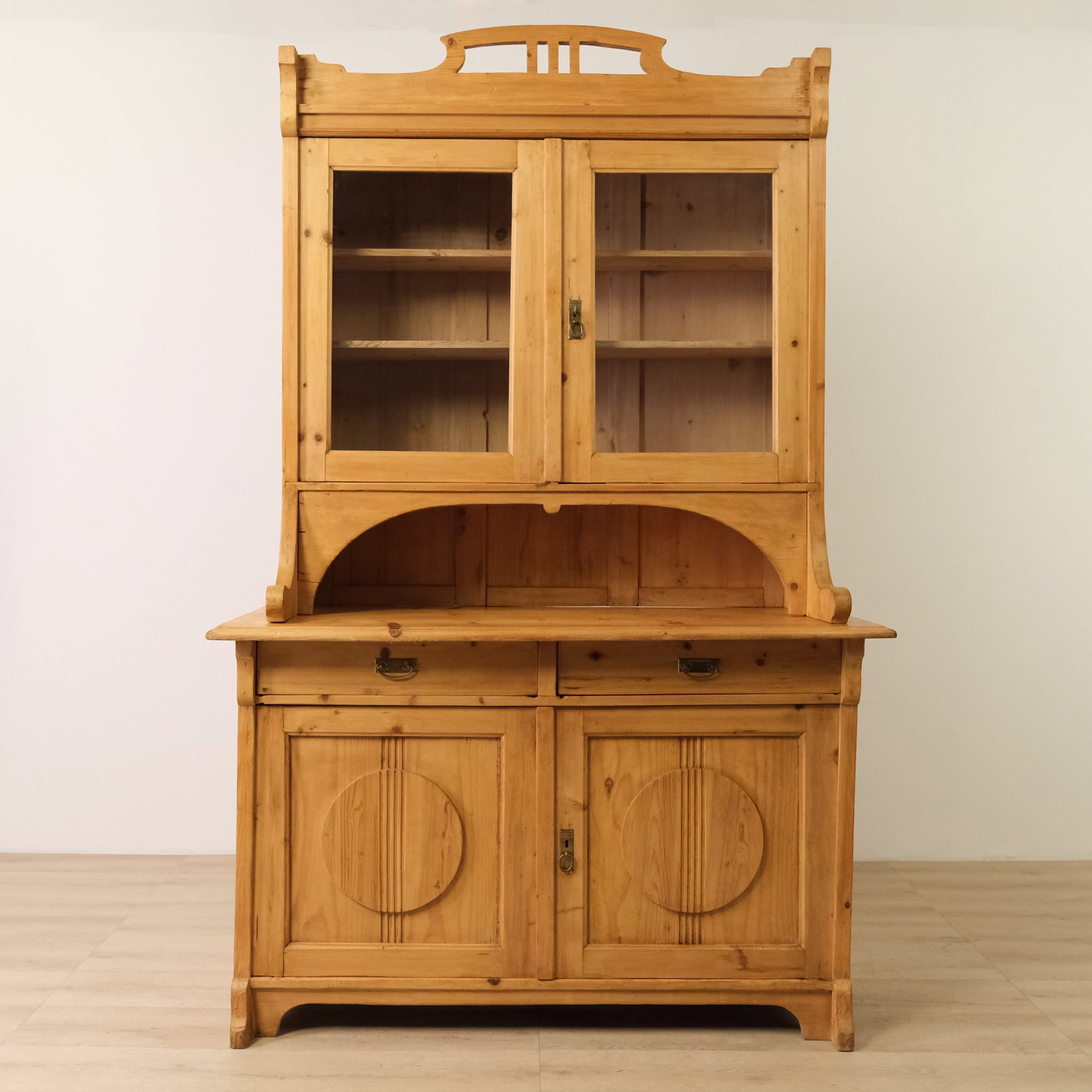 Austrian Pine Step-Back Hutch, c. 1890: This late 19th century two-piece Austrian step-back hutch in pine has a bright, sunny farmhouse presence with a touch of Art Nouveau flair. The upper cabinet steps back over a generous work surface,