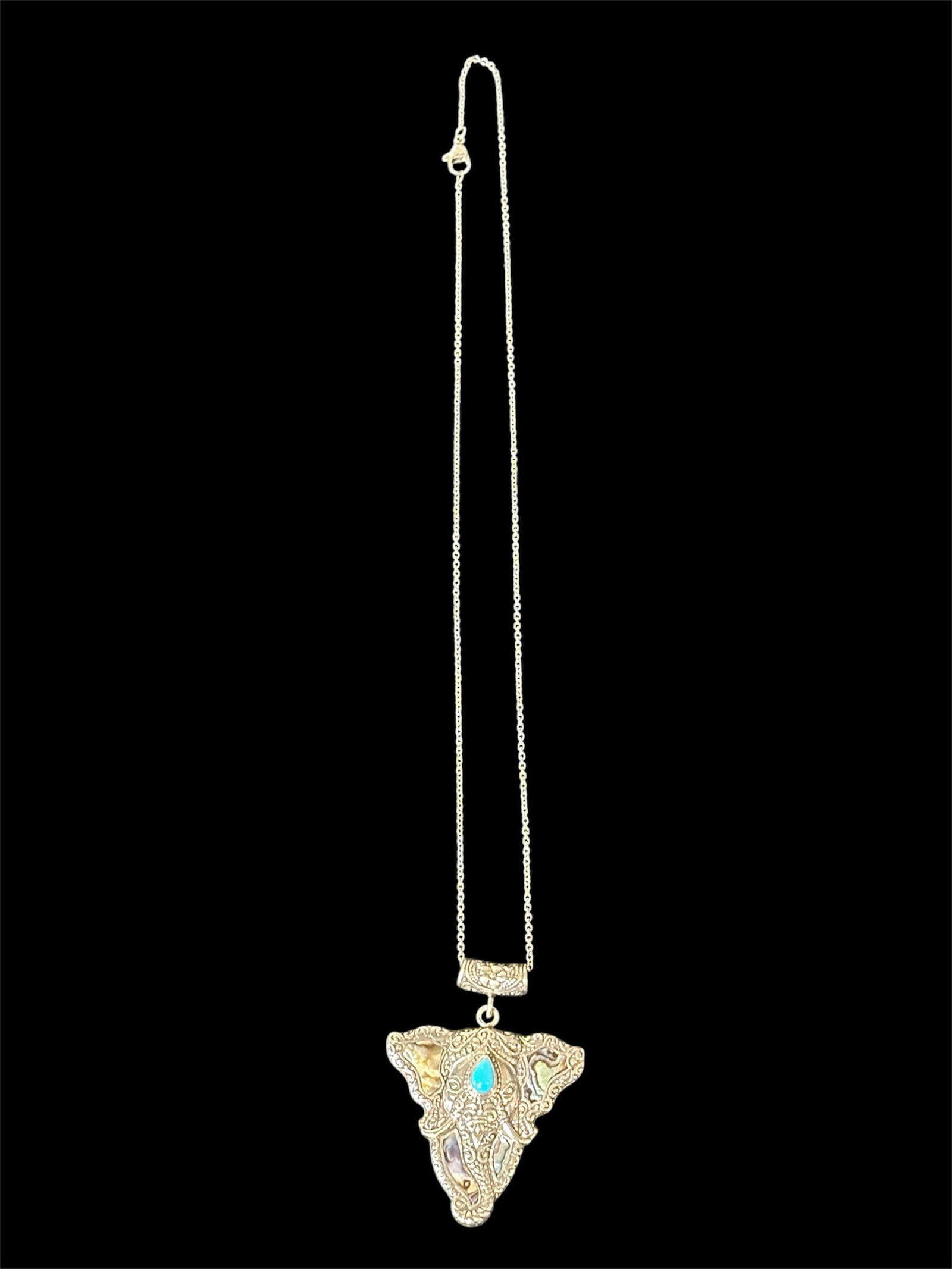 Elephant head pendant necklace: Ornate elephant head pendant necklace with turquoise stone.