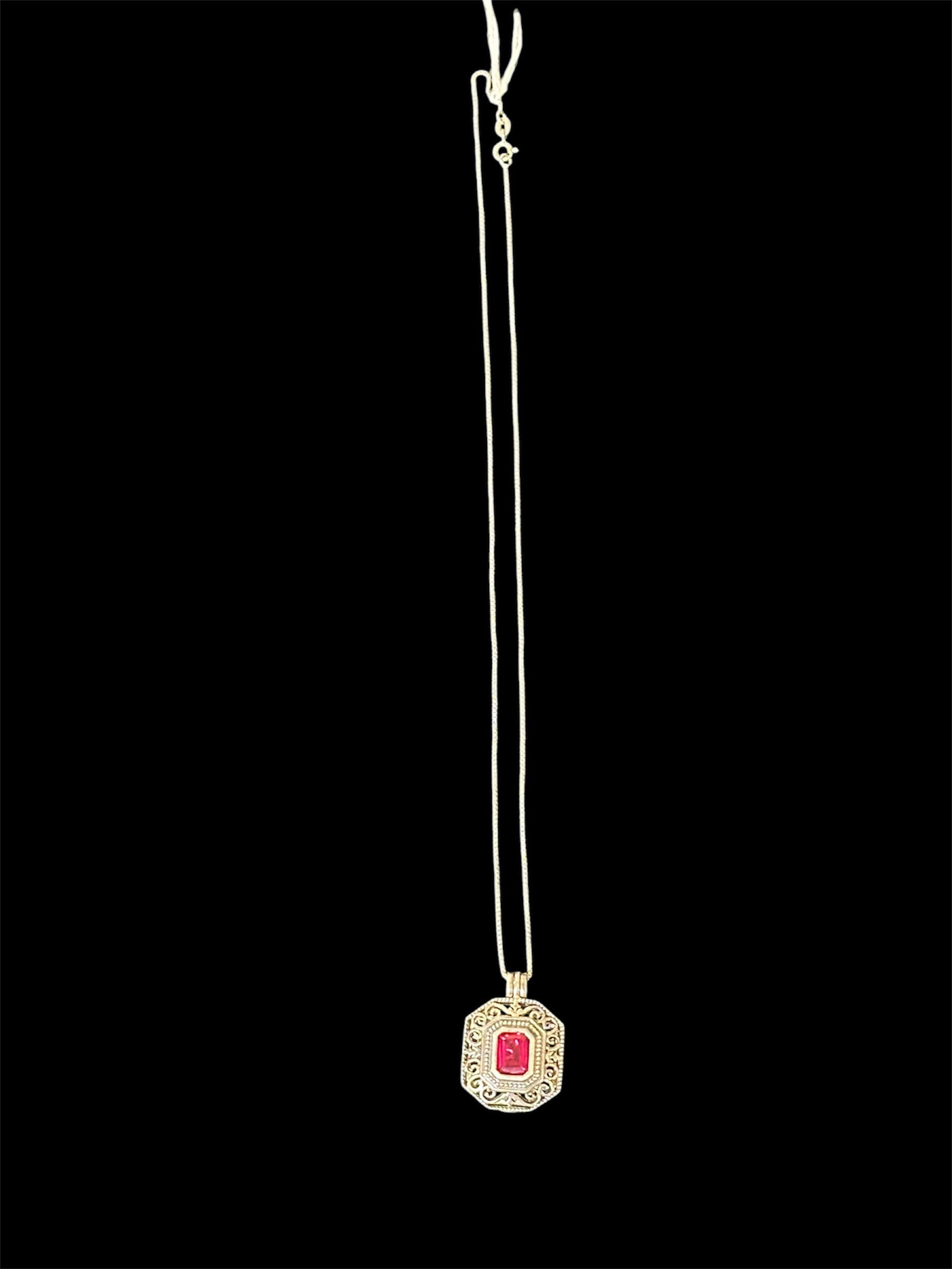 Vintage-style pendant necklace: Vintage-style pendant necklace with a red stone and ornate filigree.