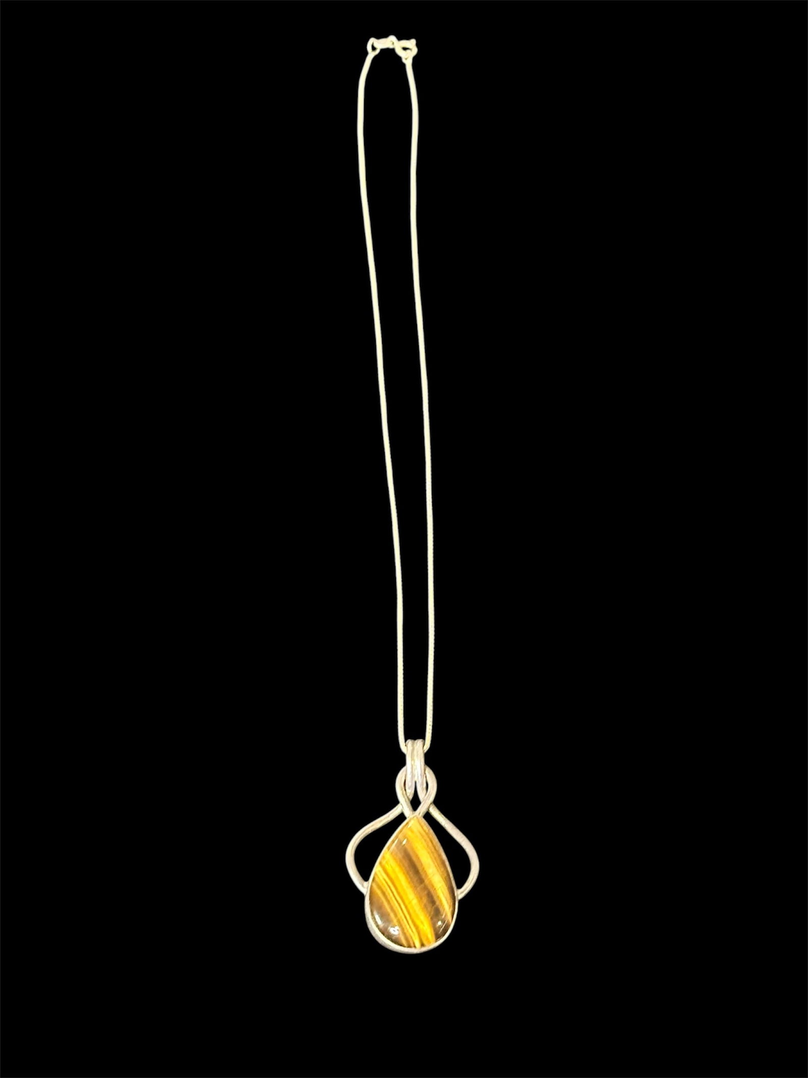 Sterling Silver Pendant Necklace: Sterling silver pendant necklace with a teardrop tiger's eye gemstone.