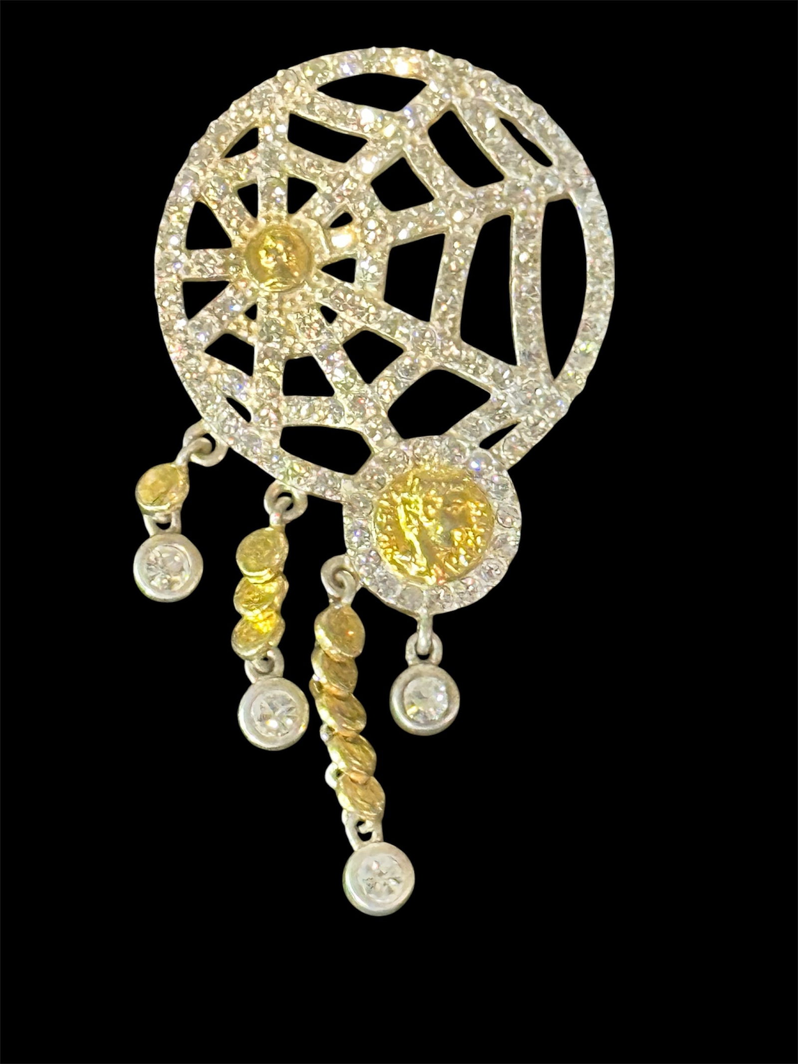 Dreamcatcher Pendant: A contemporary dreamcatcher-style pendant with cubic zirconia and gold-tone accents.