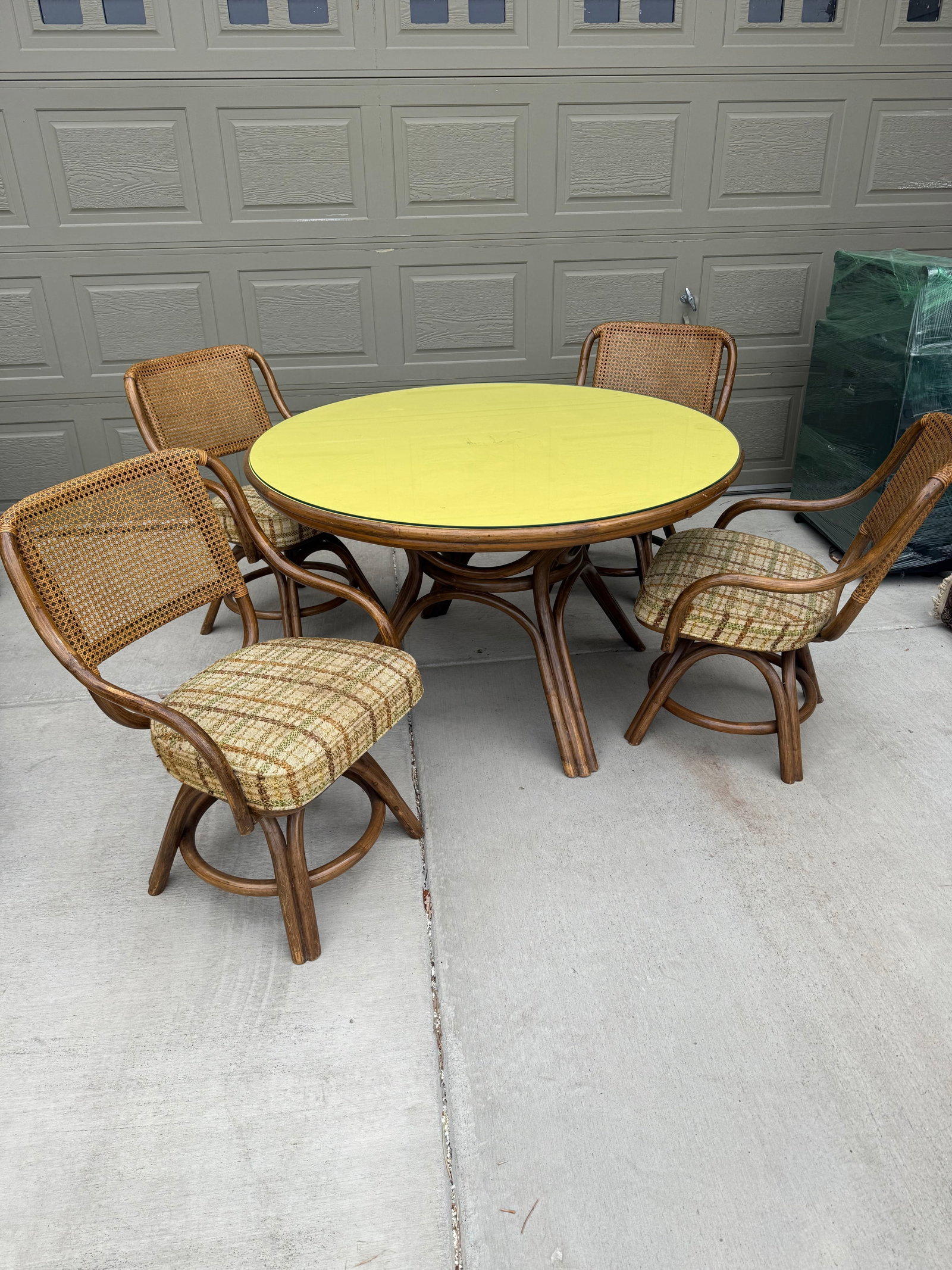 Vintage 1970's Kitchen table 4 Chairs: Cane and rattan with plywood top and matching glass. Made in the Phillipines.DIMENSIONS: Table- 29in H x 48.5 Diameter. Chairs- 32in H x 21.5in W x 18in D.