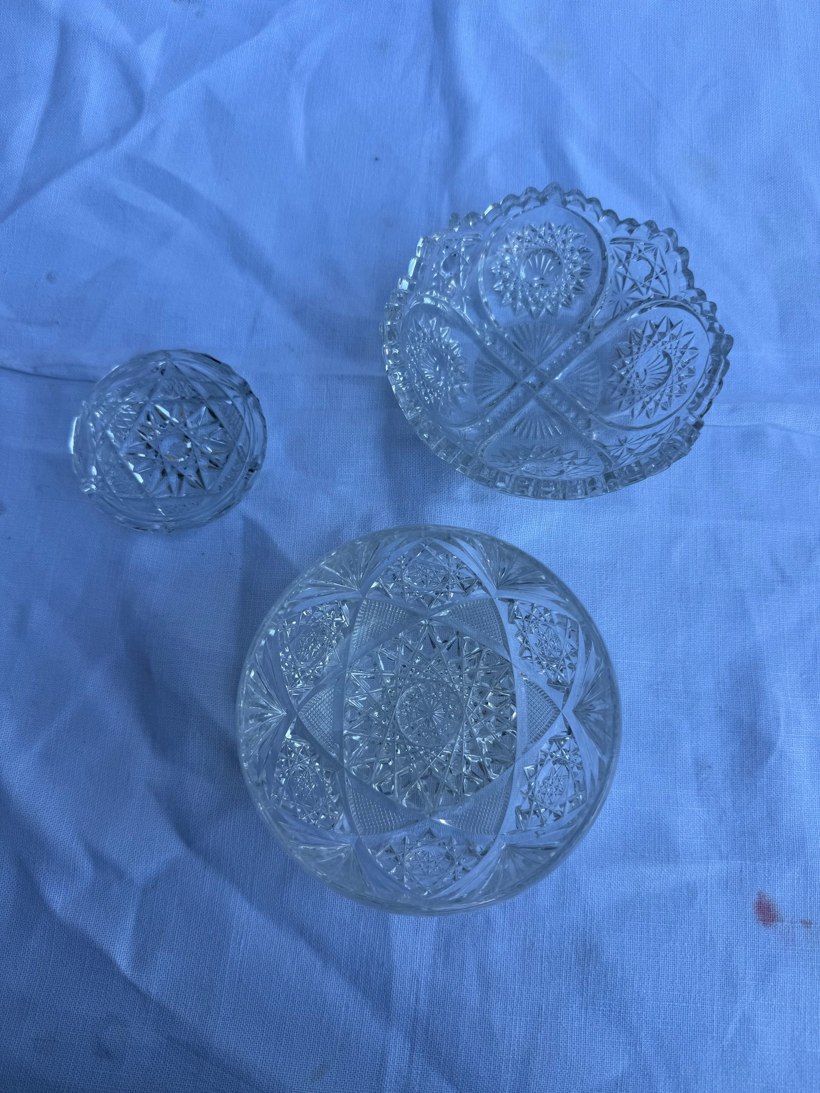 Lot of small crystal bowls and ashtrays: 6 Ashtrays. Dimensions: .5in H x 3in W. 4 Small bowls. Dimensions: 1.5in H x 5in W. 1 bowl. Dimensions: 2.5in H x 4.25in W. Minor chips as pictured.