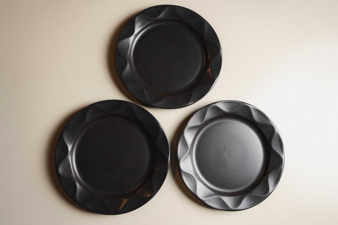 Dansk "Origami" Plates, Set of 3: Presenting a set of three 'Origami' Plates by Dansk, a design that perfectly captures the Scandinavian aesthetic of clean lines and understated elegance. Each plate features subtle geometric folds rem