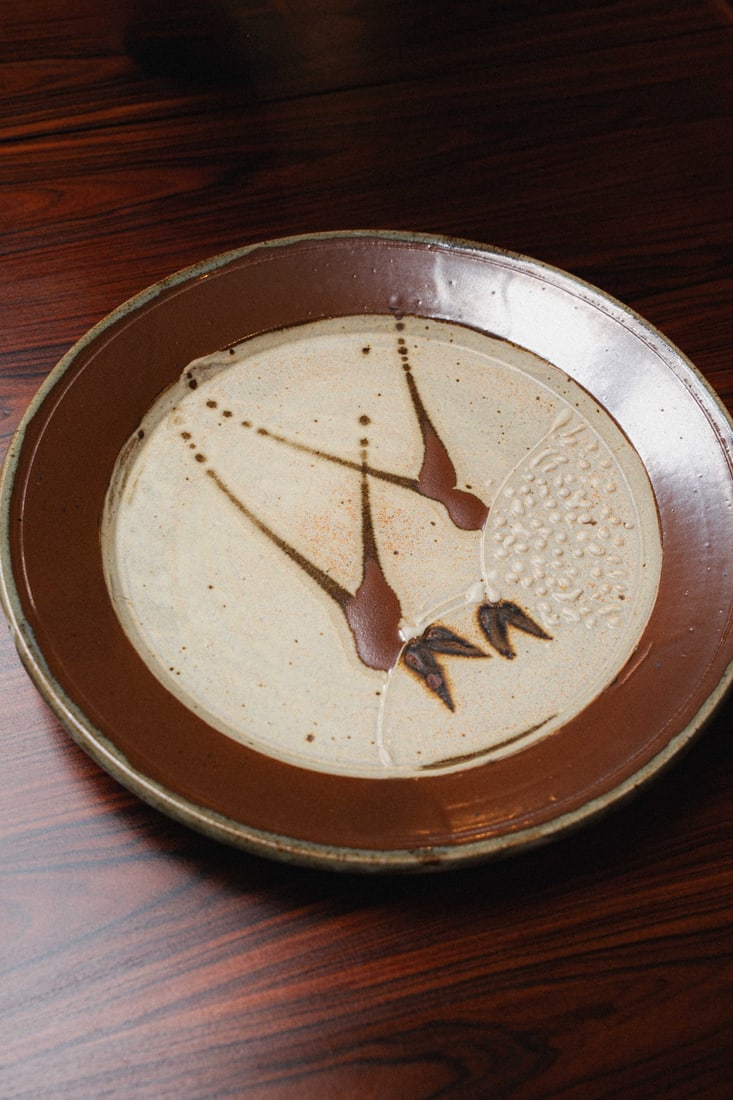 Gerald Newcomb (PNW Artist) Ceramic Plate 17", 1970s: Wheel-thrown studio pottery charger/large plate by Washington-based potter, Gerald Newcomb. This piece features a raised wheat sheaf design. Hand signed 'Newcomb' to the underside.