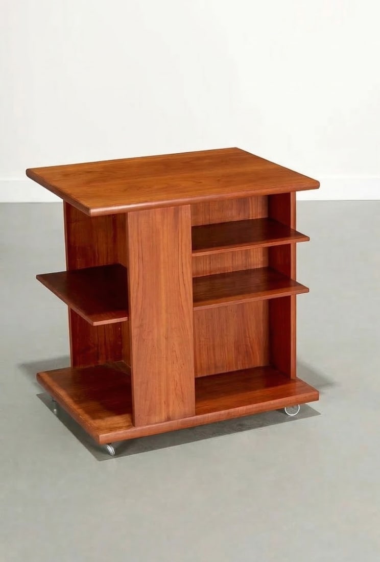 J. Ingvard Jensen Teak Rolling Bookshelf Side Table: Presenting a teak rolling bookshelf side table designed by J. Ingvard Jensen, a mid-century Danish designer celebrated for his functional, minimalist furniture and expert use of teak and other