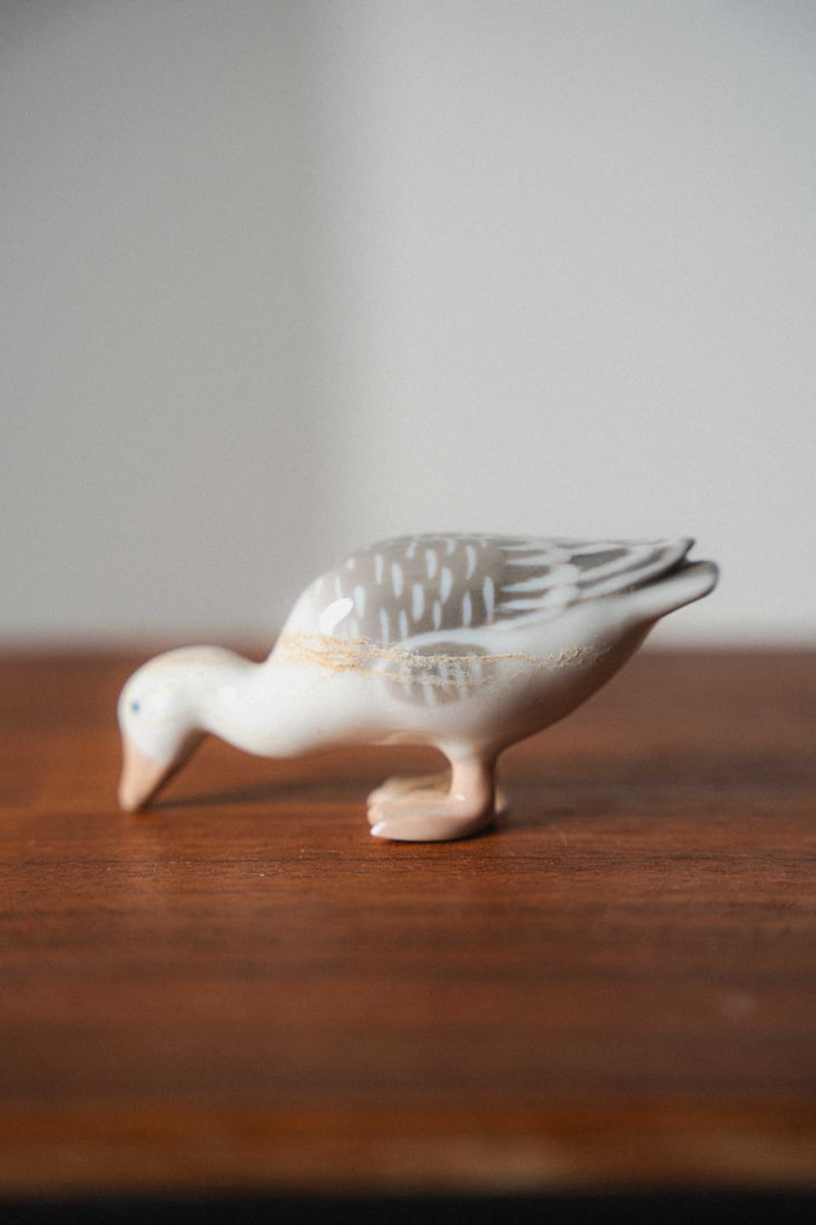 Niels Nielsen, Royal Copenhagen Bing & Grondahl Porcelain Figurine #1902, Goose: Presenting a porcelain figurine by Bing & Grøndahl, crafted in Denmark. B&G, founded in 1853, is renowned for its high-quality porcelain, delicate modeling, and hand-painted finishes, producing