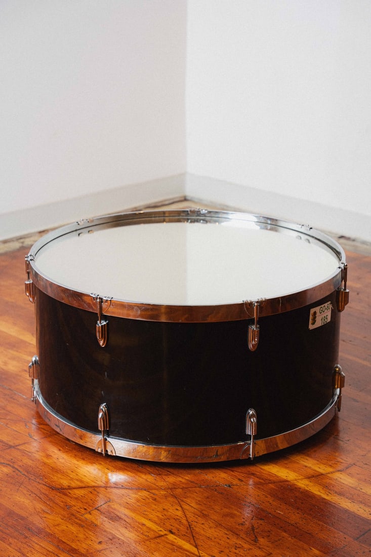Kick Drum Mirror-top Coffee/Cocktail Table: Coffee/Accent table made from a kick drum. Features a mirrored glass top. On wheels.
