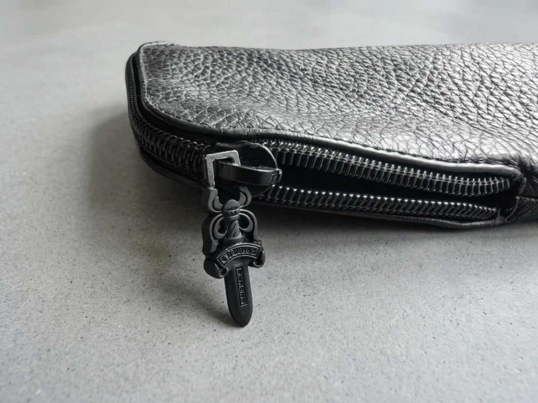 Chrome Hearts Black Soft Glasses Case Pouch. Black Dagger Zip: Chrome Hearts Black Soft Glasses Case Pouch with signature Dagger zipper pull. Soft calf leather construction in classic black. Zippered closure with iconic Chrome Hearts hardware. Sleek and