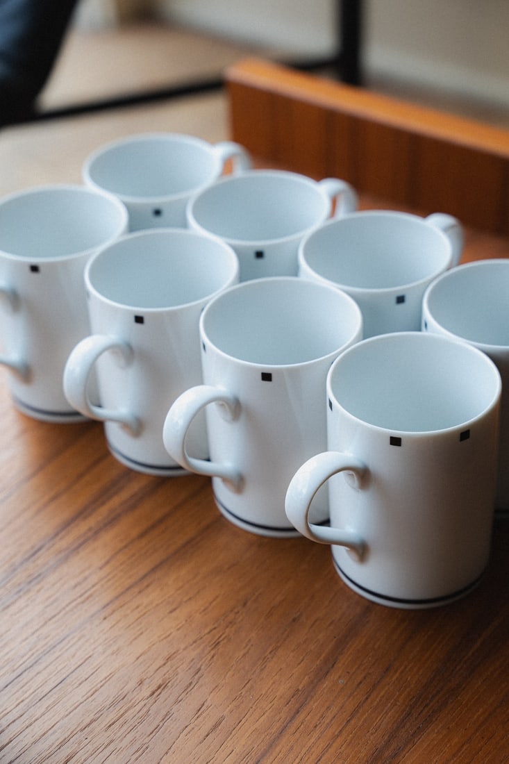Set of 8 "Metropolis Black" Mugs by David Ehrenreich for Sasaki: Presenting a set of eight 'Metropolis Black' mugs designed by David Ehrenreich for Sasaki. Ehrenreich is known for his thoughtful approach to modern tableware, emphasizing clean lines, subtle textures