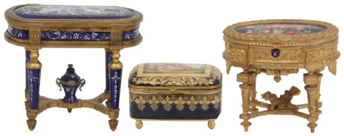 3 Jewelry Caskets: 3 Jewelry Caskets. 1) Bronze, in the form of a parlor table with deep blue enamel lid, apron, legs and urn finial having enamel filigree highlights and scene of 2 putti with dolphin in the lid. Excell