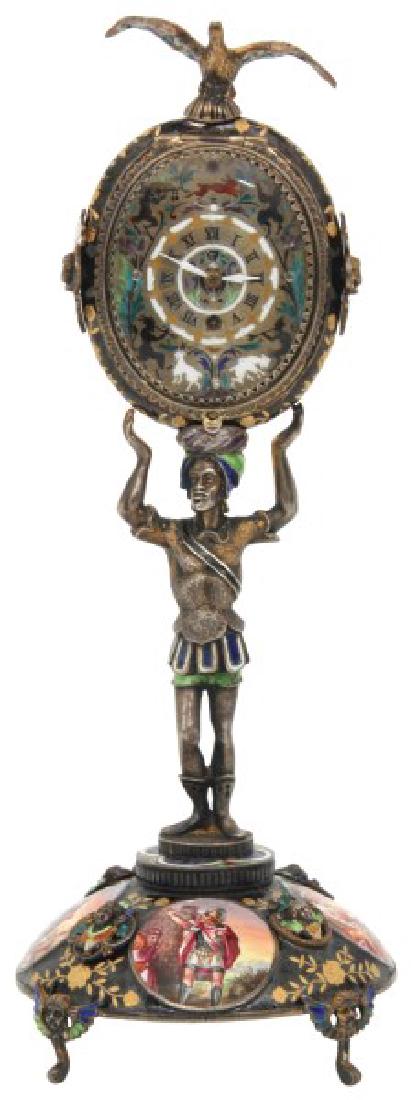 Figural Silver & Enamel Novelty Clock: Figural Silver & Enamel Novelty Clock. Enamel decorated silver case with a domical base on winged angel head feet, standing figure of an Arab man holding the large oval clock above his head with eagle