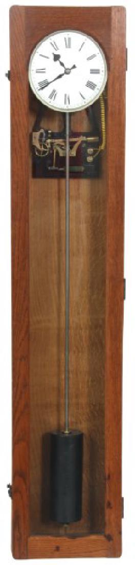 Rare Oak Synchronome Master Clock: Rare Oak Synchronome Master Clock. 7 in. silvered metal dial with black painted Roman hour numerals and silvered bezel. The electric movement is powered by a 6v No. 529 battery, a single jeweled palle