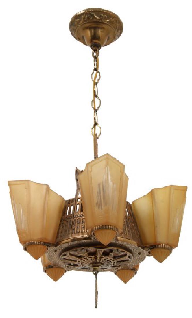Art Deco 5 Light Slip Shade Chandelier: Art Deco 5 Light Slip Shade Chandelier. Gilt cast metal fixture has pierced decorated design, large mica panel in the bottom and 5 frosted amber slip shades. Excellent condition, unsigned. Measures 27