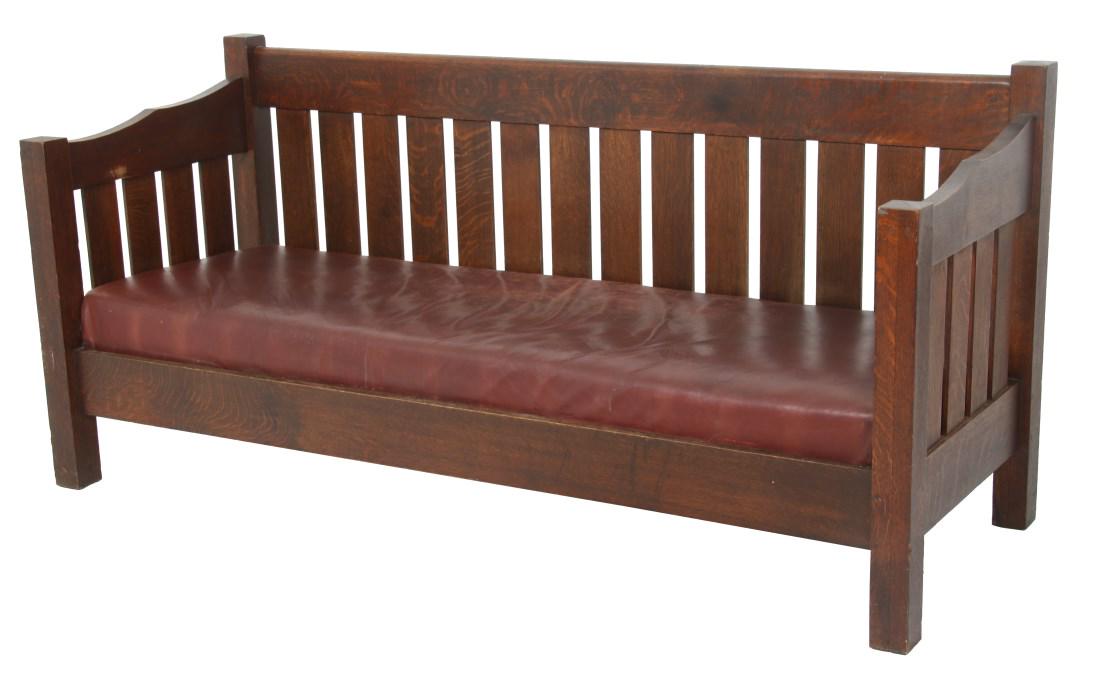 Oak Arts & Crafts Settle: Oak Arts & Crafts Settle. Has a 14 slat back with 4 slats on the sides under 3/4 drop arms; full length front and rear legs with pegged construction. Nice medium-dark brown original finish, in good ov