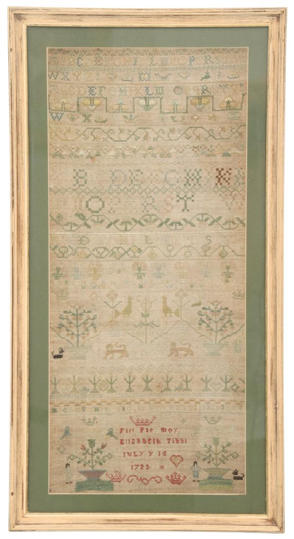 Hand Stitched Sampler "Elizabeth Tibat, 1723": Hand Stitched Sampler "Elizabeth Tibat, 1723". Early sampler with potted plants, surrounding filigree, animals and various sized alphabet samples. In French the bottom reads "Fait par Moy (Fait par Mo