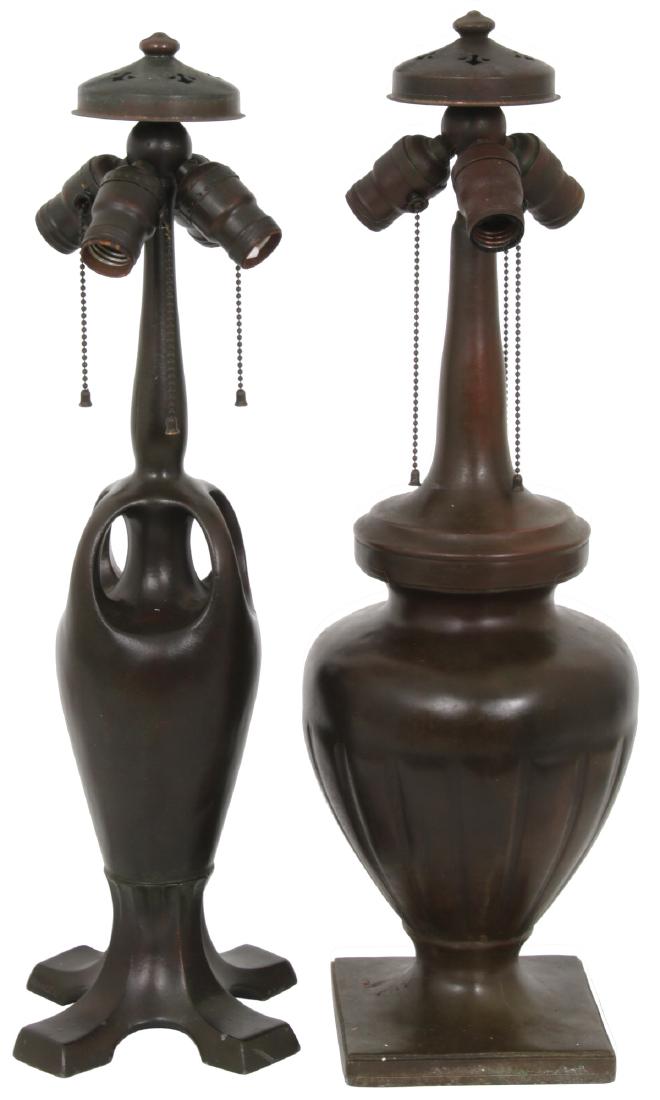 2 Signed Handel Lamp Bases: 2 Signed Handel Lamp Bases. 1) Bulbous urn form spelter base with ribbed body and long stem; spherical 3 socket light cluster with original sockets, pulls, heat cap and finial. 24 in. high. 2) Vase fo