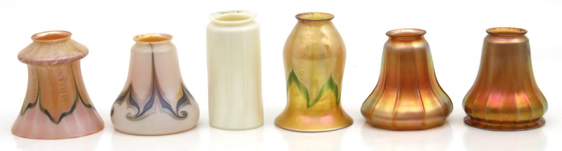 6 Assorted Signed Quezal Art Glass Shades: 6 Assorted Signed Quezal Art Glass Shades. 1) Ribbed cylindrical calcite shade, no damage. 6.25 in. high x 3 in. dia. x 2.75 in. dia. fitter. 2) Gold iridescent 10 rib shade, small fitter flake. 5 in.