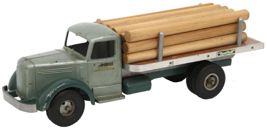 Smith-Miller Flatbed Log Truck: Smith-Miller Flatbed Log Truck. Pressed steel Mack truck with hard rubber wheels and flat bed with lumber dowels. Missing the Mack bulldog hood ornament and 1 headlight. 6.5 in. high x 20.5 in. wide x