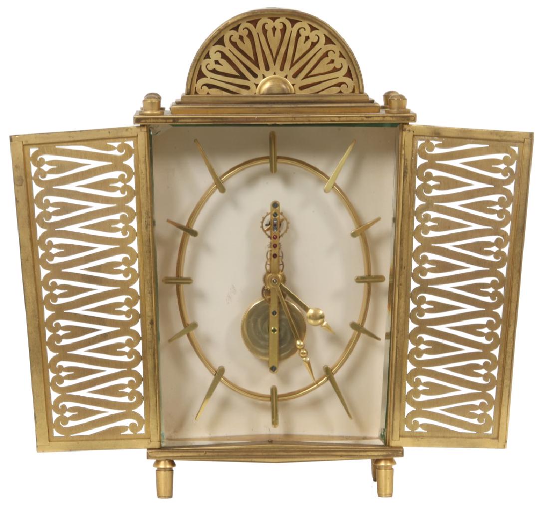 LeCoultre 2 Dr. Armoire Desk Clock: LeCoultre 2 Dr. Armoire Desk Clock. Open gilt brass oval dial with fancy gilt brass hands, exposed spring drive skeletonized 8 day inline bridge time only movement with lever escapement is in running