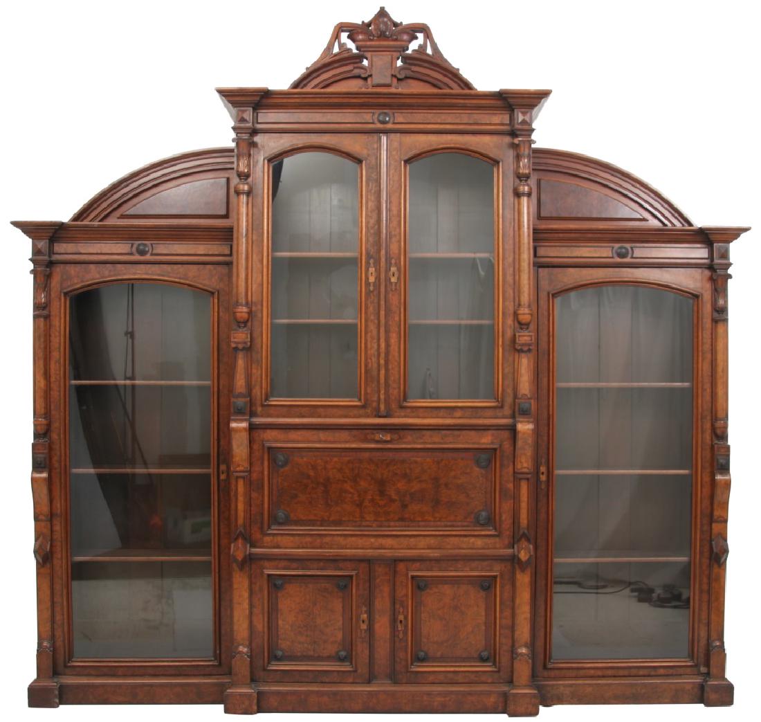 Monumental Carved Walnut Breakfront Secretary: Monumental Carved Walnut Breakfront Secretary. Tall center section with seashell and raised burled panel on the arched pediment crest, turned half columns flank the pr. of upper bookcase doors, drop f