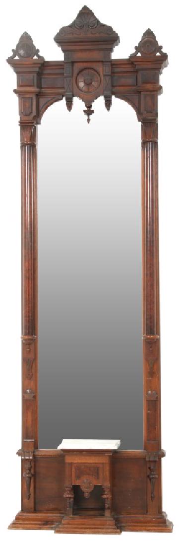 Carved Walnut Marble Top Pier Mirror: Carved Walnut Marble Top Pier Mirror. Renaissance Revival seashell carved center crest with medallion and seashell side crests, large turned rosette in the center and raised panels; has long turned ha