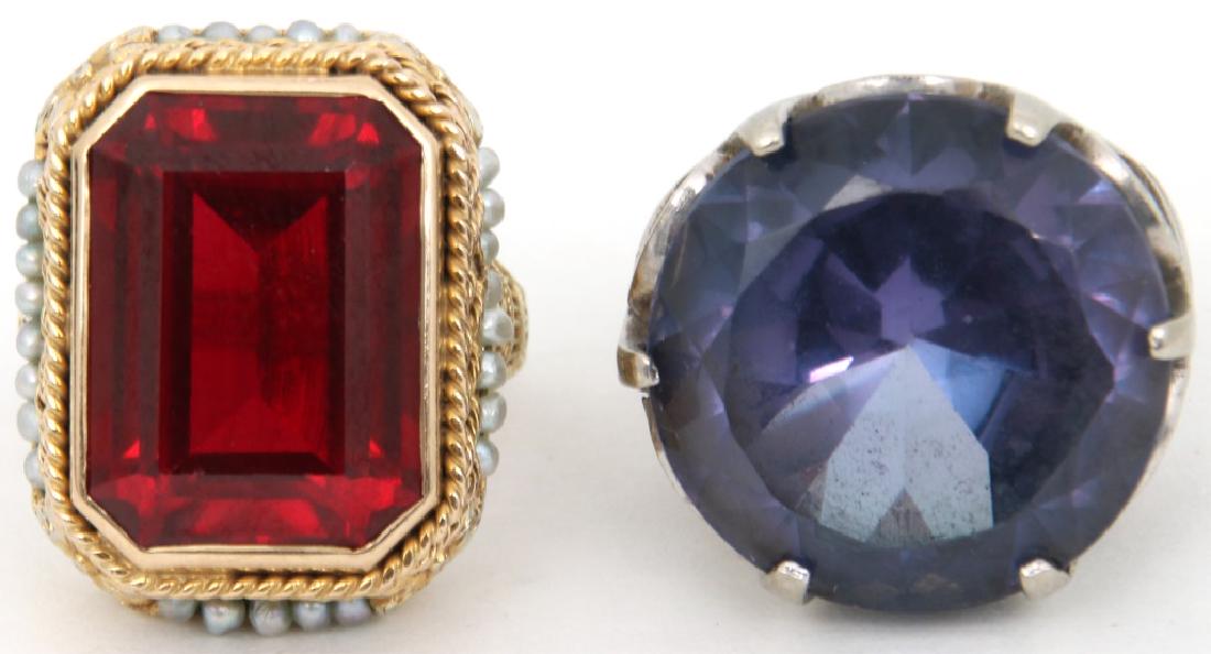 2 Fancy Estate Ladies Rings: 2 Pcs. Fancy Estate Ladies Rings. 1) Large round brilliant cut man made synthetic change of color corundum measuring approx. 20mm dia. In an 18K white gold 6 prong setting with pierced decorated highl