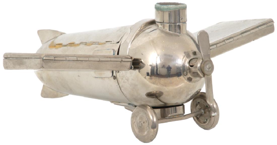 Deco Nickel Plated Aeroplane Smokers Companion: J. A. Henckels Design Deco Nickel Plated Aeroplane Smokers Companion. The nickel plated brass deco airplane is designed with a cigar cutter in the propeller with catch tray in the wheels, match holder