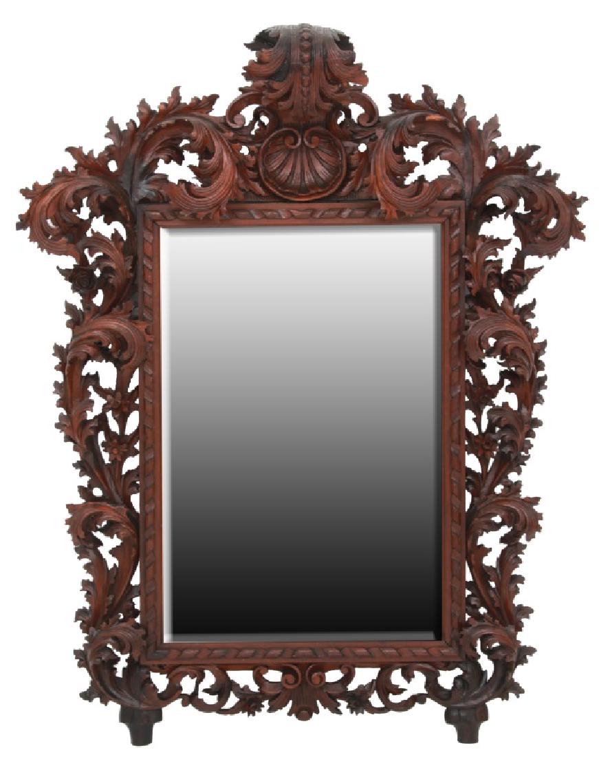 Large Filigree Carved Oak Mirror: Large Filigree Carved Oak Mirror. Crest has a curved large leaf carving hanging over a central seashell with beautiful open carved flowing filigree and flowers around the frame and has a large beveled