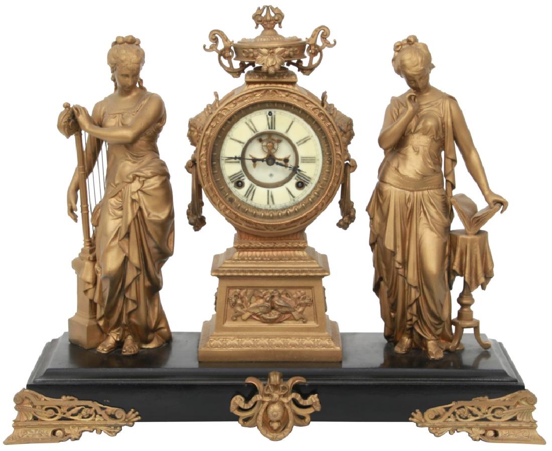 Ansonia Figural Mantle Clock "Music & Poetry": Ansonia Double Figure Mantle Clock "Music & Poetry". 2 cast spelter figures representing an allegory of Music and Poetry, standing on a black enamel decorated iron base with cast spelter mounts and a 