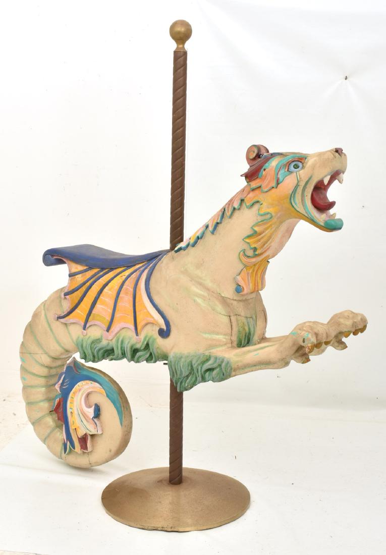 Herschell-Spillman Carousel Sea Monster Figure: Herschell-Spillman carousel sea monster ca. 1910, has large front paws and a coiled tail; in nice old park paint. Acquired by the consignor from an Indiana Toy Museum at its closing. Figure: 52 in. hi