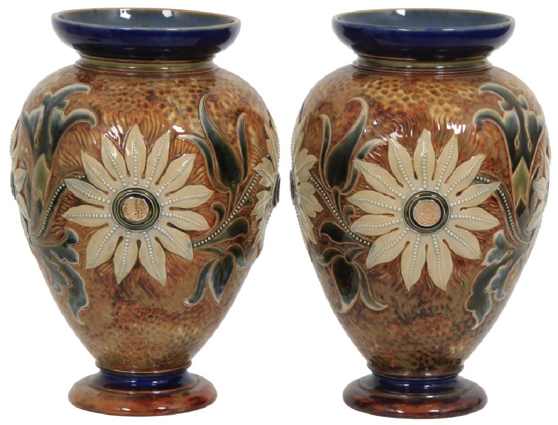 Pair Of Doulton Lambeth Pottery Vases: Pair Of Doulton Lambeth Pottery Vases. 12.5 in. high pottery vases with carved sunflower and leaf pattern having a hammered copper textured surface; signed "Doulton Lambeth, England" and has 3 artist