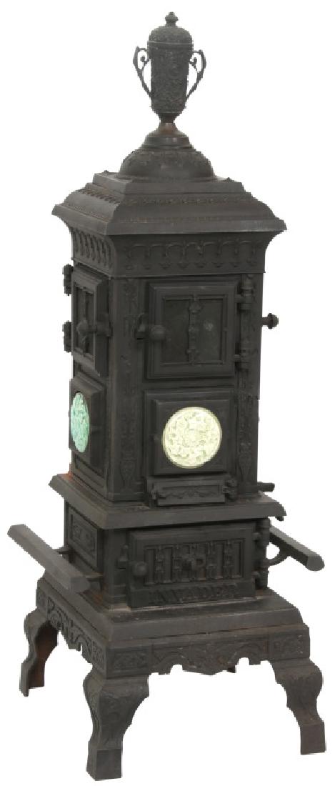Cast Iron Parlor Stove with Tile Inserts: Cast Iron Parlor Stove w/ Tile Inserts. Stove has a square form with relief decorated Filigree, large 2 handled urn top multiple access doors and 3 relief filigree decorated round green tile inserts;
