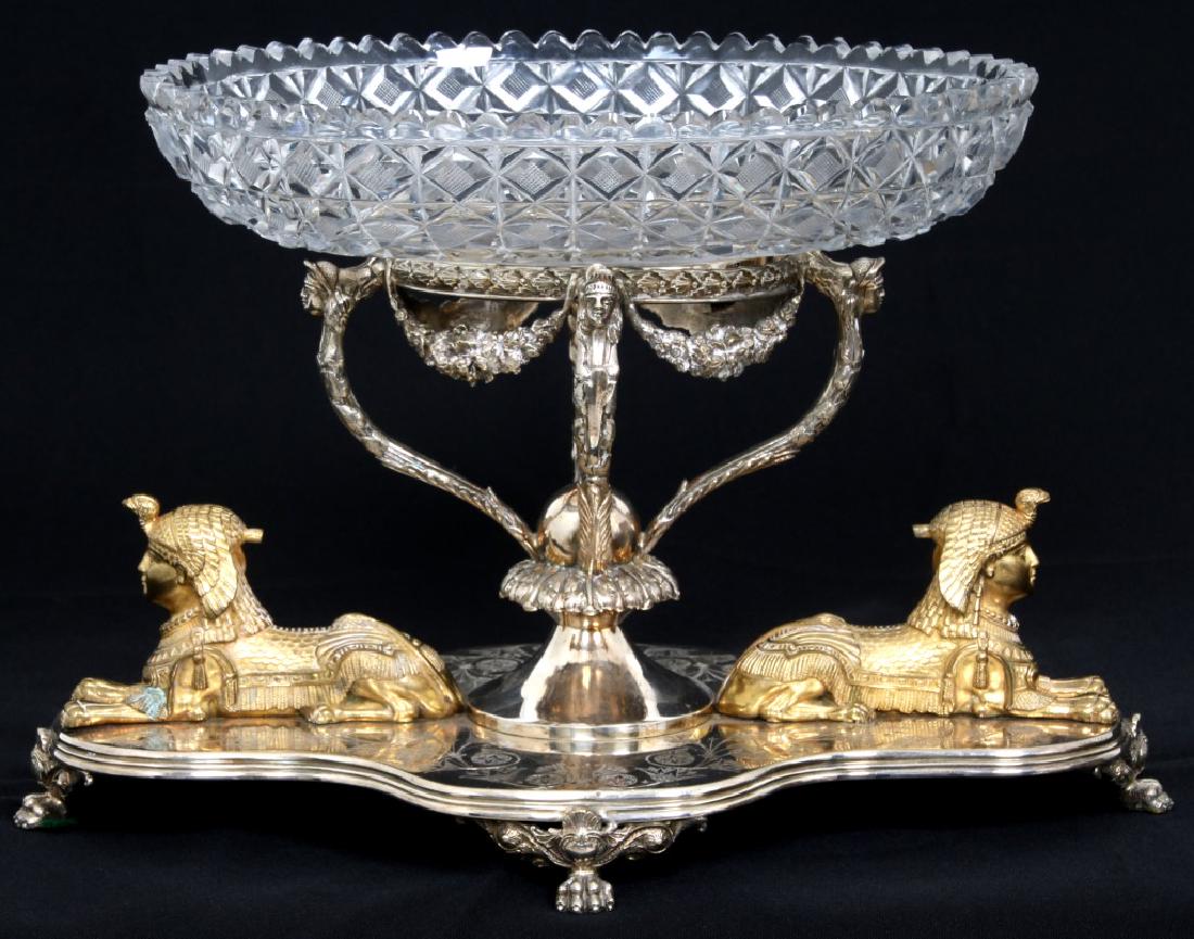 Mappin Brothers Silver Plated Centerpiece: Mappin Brothers Silver Plated Centerpiece. The silver plated base has claw feet, gilt figural sphinxes, floral garland and maiden's heads; has an oval cut glass center bowl insert. Signed on the base 