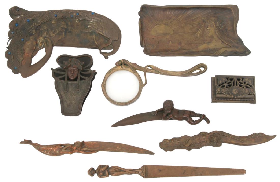 9 Art Nouveau Bronze Desk Set Pieces: 9 Art Nouveau Bronze Desk Set Pieces. Includes 2 pen trays (1 with turquoise and seed pearls), 4 letter openers, paper clip, magnifying glass and stamp box. Smaller pen tray signed "Maxim", letter ope