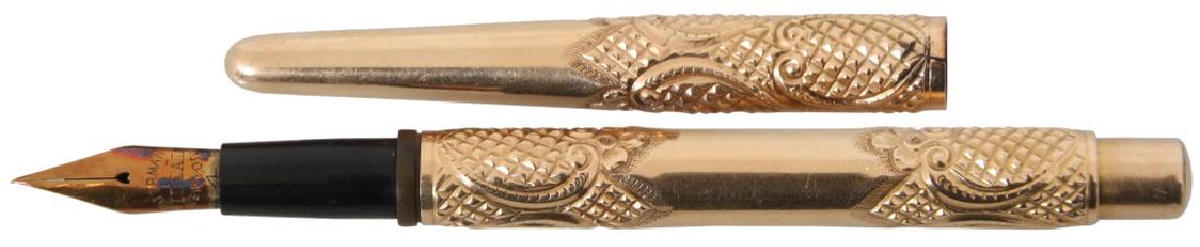 Waterman's Ideal Gold Fountain Pen: Waterman's Ideal Gold Fountain Pen. Fountain pen having a repousse-decorated scrolling design and flexible nib; has Waterman number 524 and engraved "Waterman 14KT." There is a 4 mm crack on the botto
