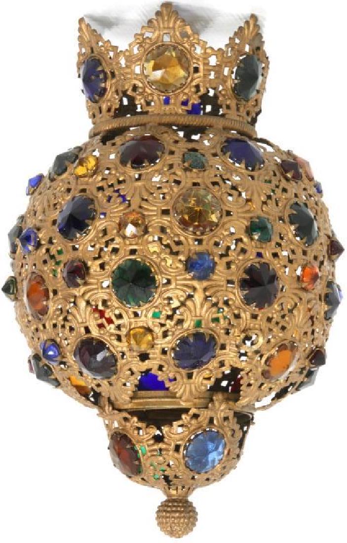 Jeweled Pull-Down Hall Lamp Shade: Jeweled Pull-Down Hall Lamp Shade. Pierced filigree decorated brass frame with flaring crown, mounted with faceted multi colored glass jewels. 1 missing jewel. Dimensions: 10.5" high x 7" wide x 7" de